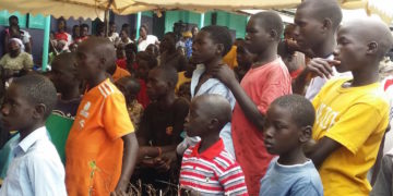 Away from court, Ongwen plays football and cleans the detention centre