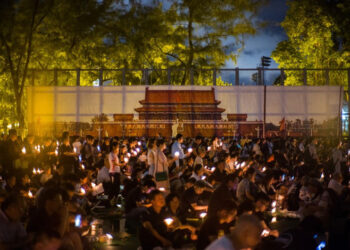 People hold candles in front of a backdrop showing Beijing's Tiananmen Square during a vigil in Hong Kong on June 4, 2018, to mark the 29th anniversary of the 1989 Tiananmen crackdown. Credit: Anthony Wallace/AFP