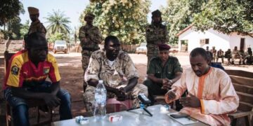 Hassan Bouba Ali (R) with Ali Darassa (C) surrounded by other UPC leaders, during a meeting at their headquarters in Alindao, October 2017. © 2017 Alexis Huguet Photo: Human Rights Watch
