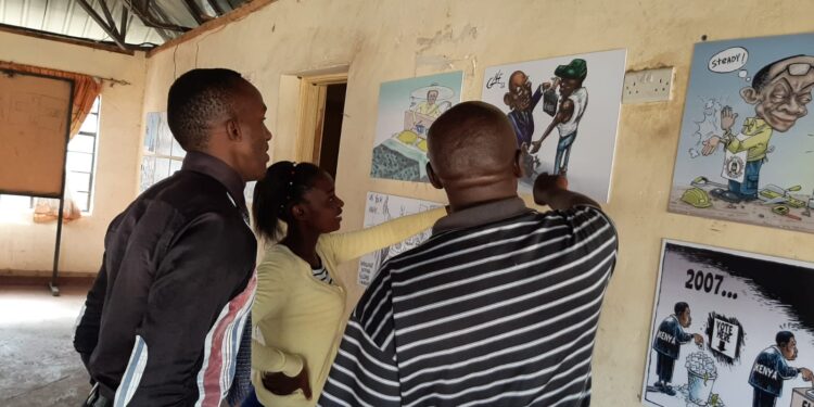 Nakuru residents at the “Justice Through African Eyes” cartoon exhibition at the Nakuru Social Hall on March 31, 2022. Photo credit: @Waceke Njoroge