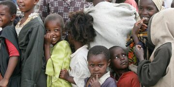 Kenyan families displaced by the 2007/2008 post-election violence queue at Shalom City, a camp for internally displaced persons located outside Naivasha town in the Rift Valley region. (Photo: Mothers Fighting For Others/Flickr)