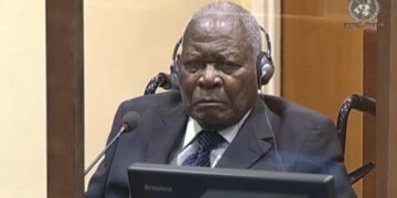 Rwandan genocide suspect Félicien Kabuga listens to proceeding during a status conference at the United Nations International Residual Mechanism for Criminal Tribunals courtroom in The Hague on August 18, 2022. His trial starts on September 29, 2022.