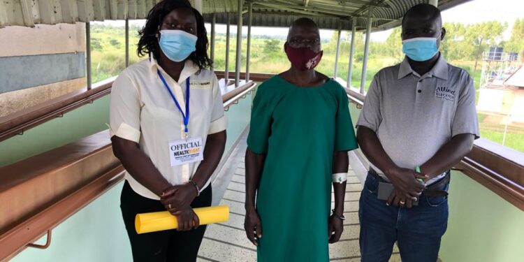 From left: Charity of Health Right International, Charles Ocaya, and Jimmy Otim, Field Outreach Assistant, International Criminal Court, Uganda, during a surgical camp at Anaka General Hospital. Mr Ocaya, a victim of the Lord’s Resistance Army insurgency in northern Uganda, was waiting for surgery.