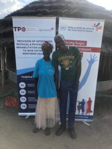 Santa Ajok and Albert Ocen pose for a photo in Pader district, northern Uganda, after speaking to Journalists For Justice. Photo credit: Journalists for Justice   